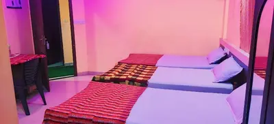 a room with two beds in a pink room at geo gardens residency in Alwaye