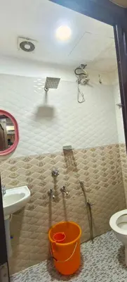 a bathroom with a shower and a toilet and a sink at geo gardens residency in Alwaye