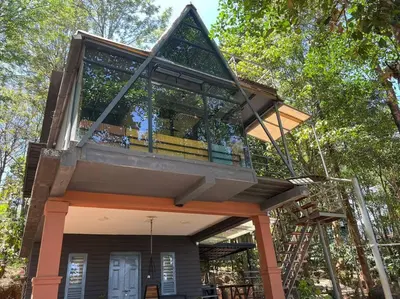 a tree house in the middle of a forest at Wildrootstay 3 bed cottage in Pinangode