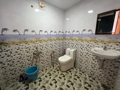a bathroom with a toilet and a sink at Happy Villa Homestay - 2 in Chelakara