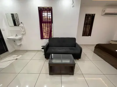 a living room with a couch and a coffee table at RK Residency Calicut in Kozhikode