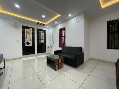 a living room with a chair and a coffee table at RK Residency Calicut in Kozhikode