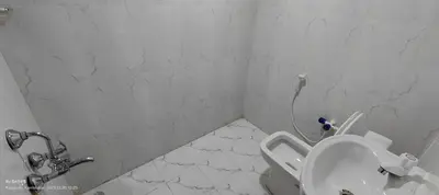 a white bathroom with a toilet and a shower at Streaming Valley Independent Coffee Estate Stay in Madikeri