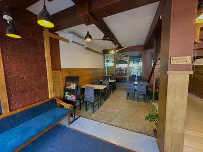 an overhead view of a restaurant with tables and chairs at Rio Rooms Calicut Near Mims Hospital in Kozhikode