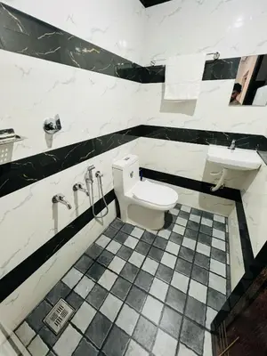 a bathroom with a toilet and a sink at Happy Land in Shoranūr