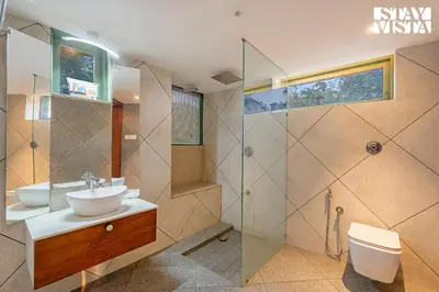 a bathroom with two sinks and a shower at StayVista at Own The Beach Life - 1 BHK Pet Friendly - Beach View in Trichūr