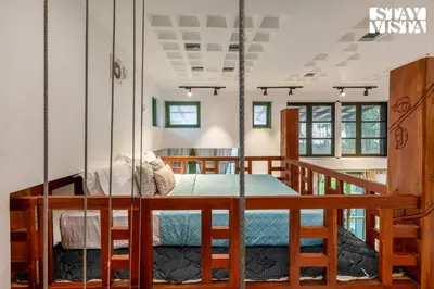a room with a bed with a swing in it at StayVista at Own The Beach Life - 1 BHK Pet Friendly - Beach View in Trichūr