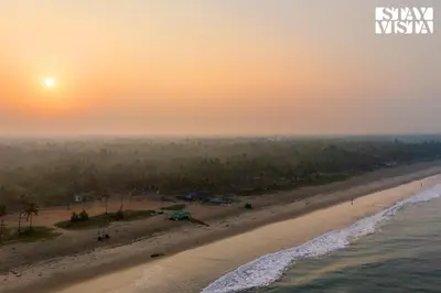 an aerial view of a beach at sunset at StayVista at Own The Beach Life - 1 BHK Pet Friendly - Beach View in Trichūr