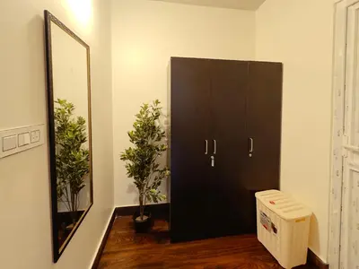 a black cabinet in a room with a mirror at Ooty Boulevard in Ooty