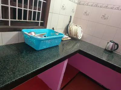 a blue bin on a counter in a kitchen at Shivalaya Stays - Coimbatore in Coimbatore