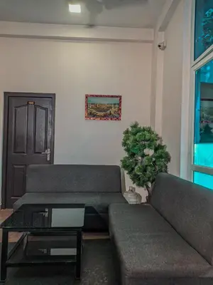 a living room with a couch and a table at Raaha Residency in Kozhikode