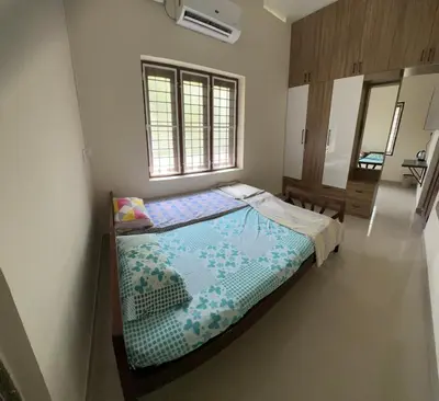 a bedroom with a bed and a window at Lilly in Alattūr