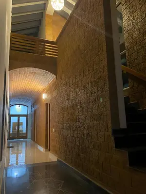 a hallway of a building with a brick wall at Red Rock Villa, Virajpet, Coorg in Virajpet