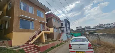 a car parked in front of a house at OOTY STAY AWHILE in Ooty