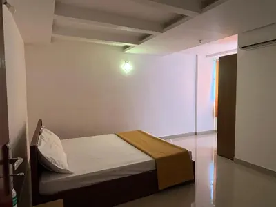 a small bedroom with a bed in a room at Plaza Residency in Badagara