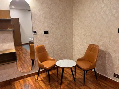 a waiting room with two chairs and a table at THE CONTINENTAL INN & SUITES in Mysore