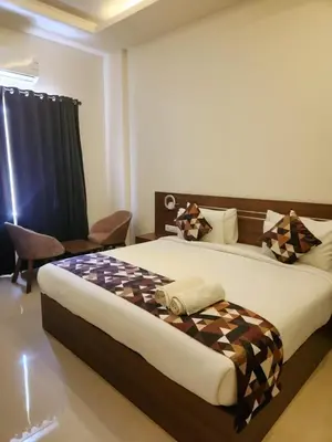 a bedroom with a large bed in a room at Le Sanara Residency in Thanniyam