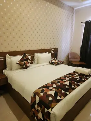 a bedroom with a large bed with a checkeredkered at Le Sanara Residency in Thanniyam