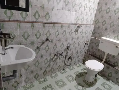 a bathroom with a toilet and a sink at Verdant Hillock in Wayanad