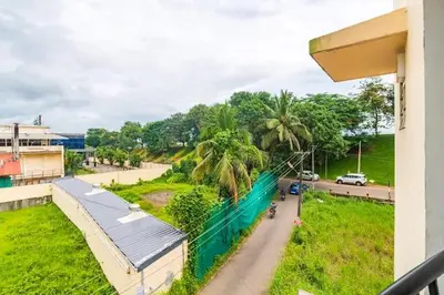 a view from a balcony of a road with palm trees at VVP Service Apartments in Nedumbassery