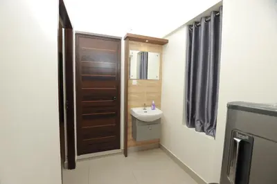a small bathroom with a sink and a toilet at VVP Service Apartments in Nedumbassery