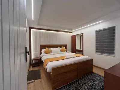 a bedroom with a large bed in a room at Fortune Retreats in Ooty