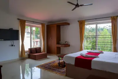 a bedroom with a bed and a large window at Green Premium Villa Ooty by Lexstays in Ooty