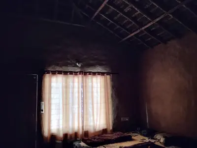 a room with a window with a curtain at Cosmic Mud House Kanthalloor in Kanthalloor