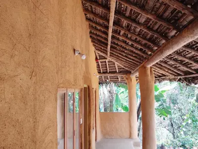 an outside view of a building with an open door at Cosmic Mud House Kanthalloor in Kanthalloor