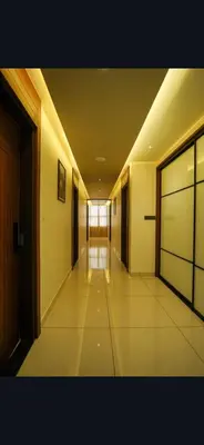 an empty hallway of a building with a hallway at Hotel Harigovindas Express Mysore in Mysore