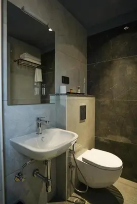 a bathroom with a sink and a toilet at Hotel Harigovindas Express Mysore in Mysore