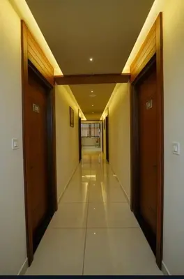 a hallway of a building with two doors and a hallwayngth at Hotel Harigovindas Express Mysore in Mysore