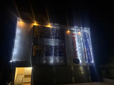 a building with lights on the side of it at night at MADAVATH RESIDENCY in Kenichira