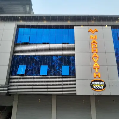 a building with a sign on the side of it at MADAVATH RESIDENCY in Kenichira