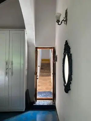 a hallway with a mirror on the wall and a hallway with a door at Shantam Homestay - Powered by Grackle in Cheruthuruthi