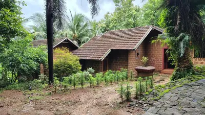 a brick house with a garden in front of it at Shantam Homestay - Powered by Grackle in Cheruthuruthi