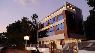 a building with lights on top of it at Manu's Home Stay in Malayāttūr