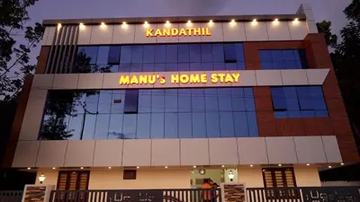 a building with a sign on top of it at Manu's Home Stay in Malayāttūr