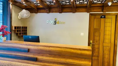 a office with a desk with a laptop on it at POOJA inn in Guruvāyūr