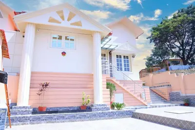 a house with pink and white at Coorg Lotus Villa in Madikeri