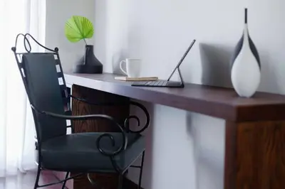 a wooden desk with a laptop and a chair at Nilgiri Valley Villa Ooty - a VKation Experience in Ooty