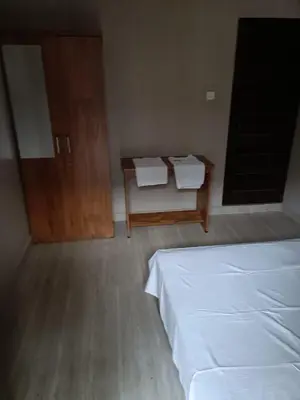 a bedroom with a bed and a desk and a table at MB Arcade in Tellicherry