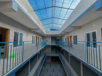 a hallway of a hospital with a glass ceiling at MB Arcade in Tellicherry