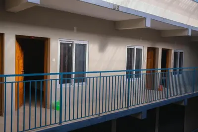 a balcony of a building with doors and windows at MB Arcade in Tellicherry