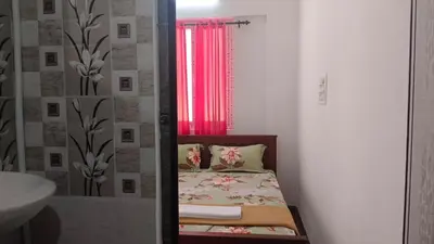 a small bedroom with a bed and a window at AYYAN RESIDENCY in Alāndurai
