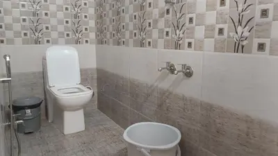 a bathroom with a toilet and a sink at AYYAN RESIDENCY in Alāndurai
