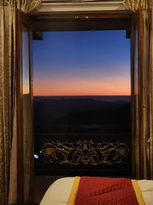a bedroom with a window with a view at Vista Sunrise Resort Ooty Dodabetta in Ooty