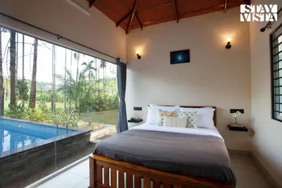 a bedroom with a bed and a swimming pool at StayVista at Palm Tree Homes with Complimentary Breakfast, BBQ Grill and Pet-Friendly Home in Wayanad