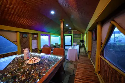 a train car with a table with a plate of food on it at Vrindhavan Mist City Resorts in Kanthalloor