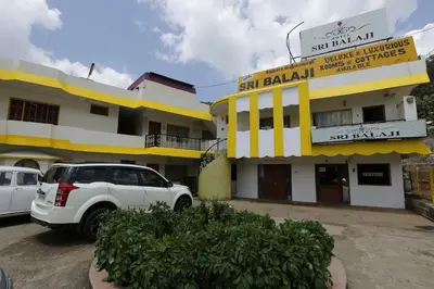 a white truck parked in front of a building at Hotel Sri Balaji in Ooty